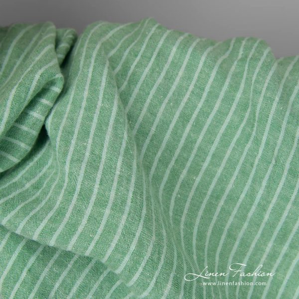 Wide washed green striped linen fabric close up detail view