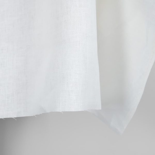 Linen fabric in plain off-white colour edge