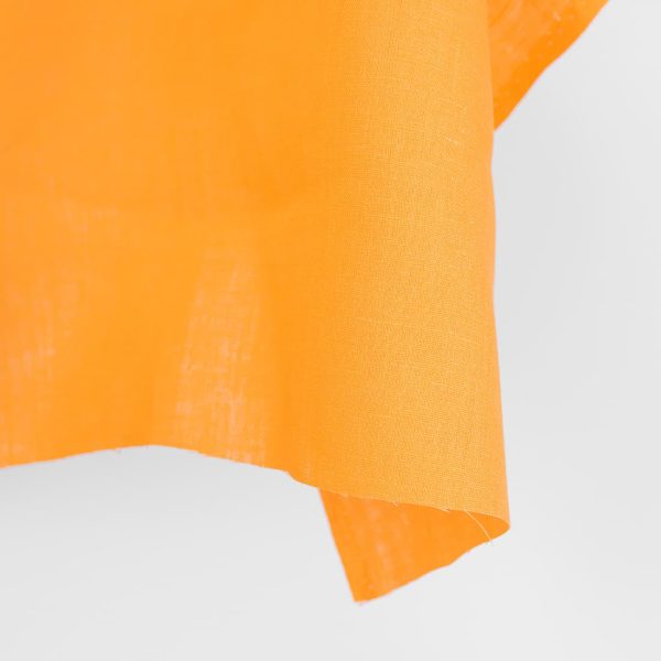 Linen fabric in plain vibrant warm yellow edge