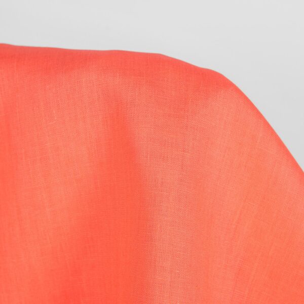 Linen fabric in living coral colour close up detail