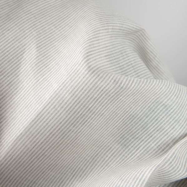 Linen fabric in natural and white colour stripes close up detail view