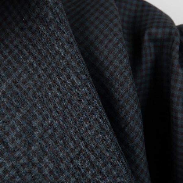 Dark linen fabric in black and blue checks close up detail view