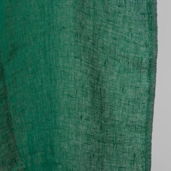 Washed linen fabric emerald green transparent close up edge view