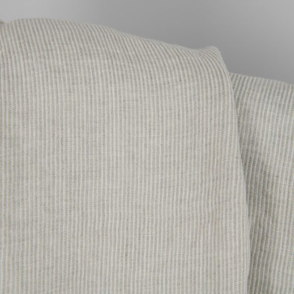 Washed linen fabric in natural and white colour stripes close detail view