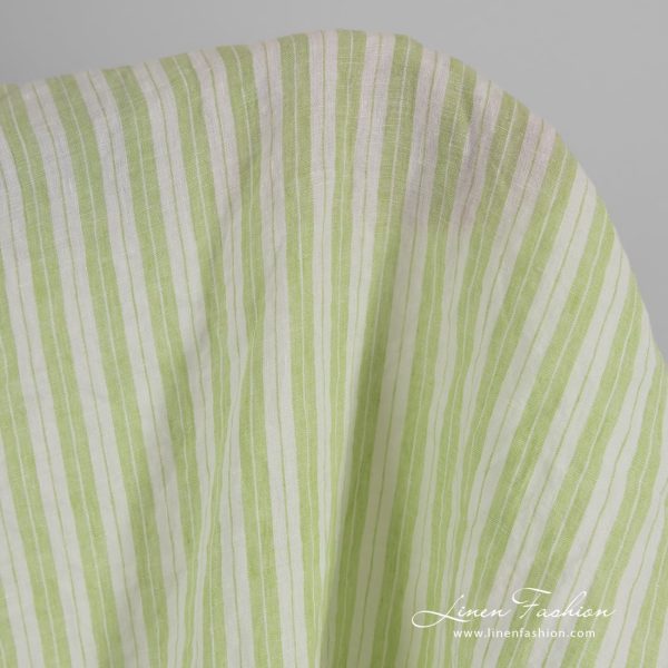 Light green linen fabric in stripes, washed