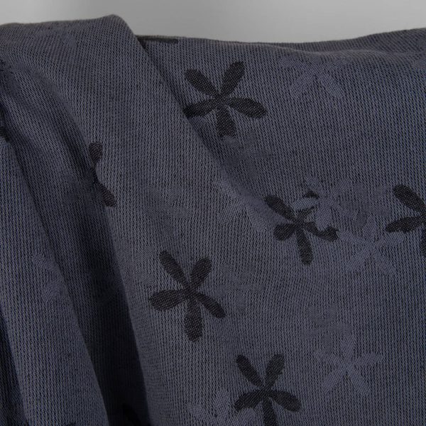 Washed linen cotton fabric with blueish grey flowers close up detail photo