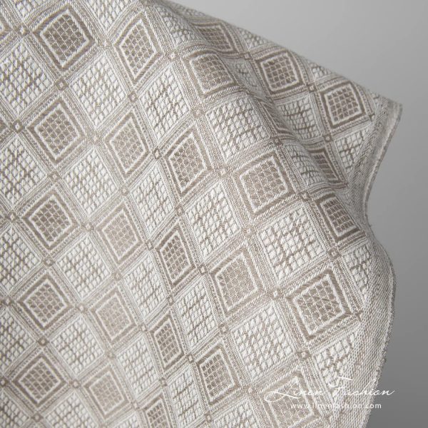 Linen cotton fabric sand colour rhombus pattern close up edge view