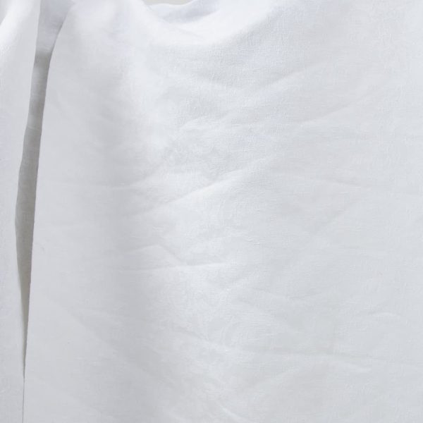 Optical white linen cotton fabric with flower ornaments product photo