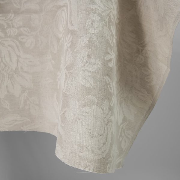 Linen cotton jacquard fabric beige with flowers close up edge view