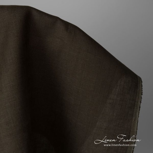Linen fabric dark moss green colour close up edge view