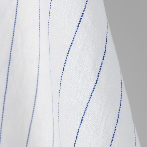 Washed linen cotton fabric white with blue stripes. Stonewashed