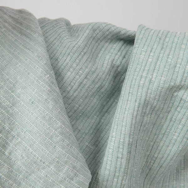Washed linen cotton fabric greenish white colour striped close up detail
