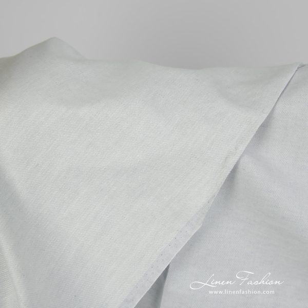Linen cotton fabric blueish green twill weave close up detail