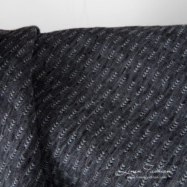 Closer view of black and grey tick pattern linen fabric, washed