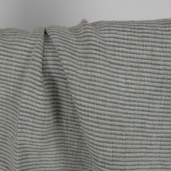 Washed linen fabric green-grey small pattern close up detail