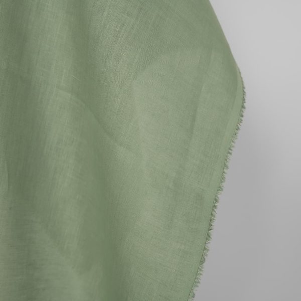 Linen fabric in muted light green, fabric edge