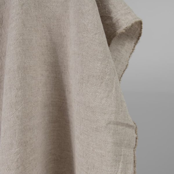 Wide washed linen cotton fabric sand colour edge view