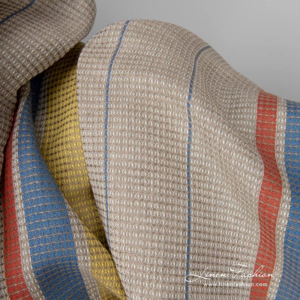 Linen cotton fabric sand waffle with yellow red stripes close up detail