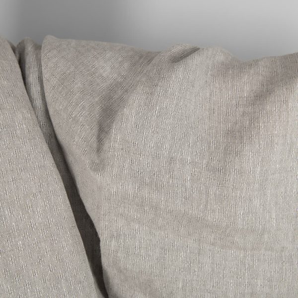 Openwork patterned linen fabric in beige close up detail