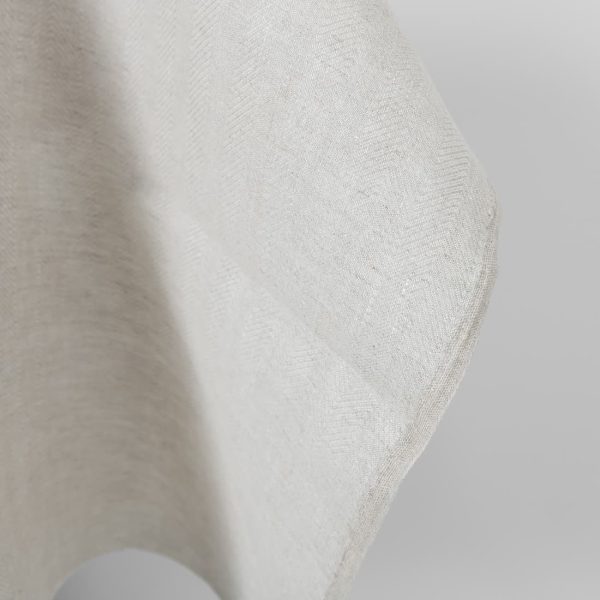 Linen fabric beige in herringbone pattern edge