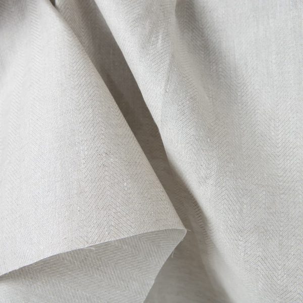 Linen fabric beige in herringbone pattern close up detail