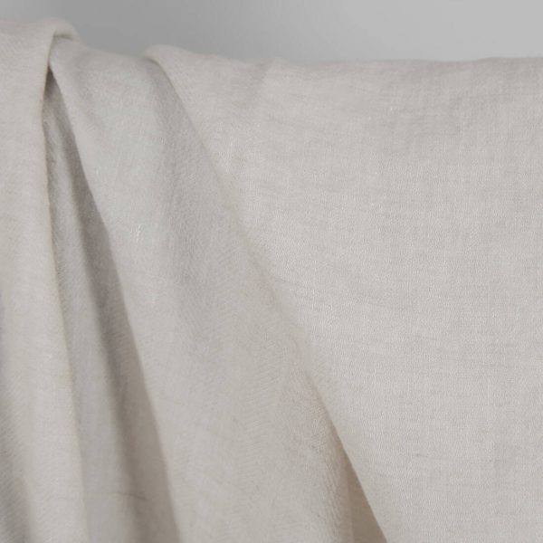 Washed linen wool fabric beige in herringbone pattern close up detail