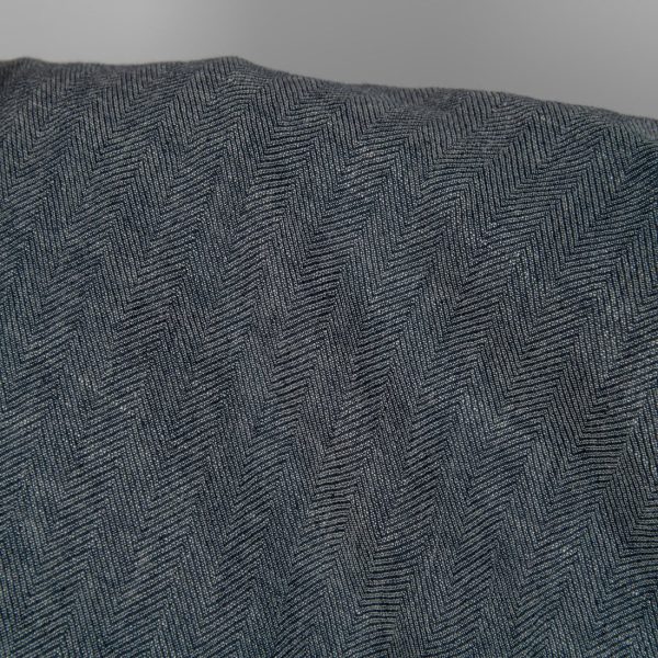 Washed linen wool fabric black white in herringbone pattern close up detail