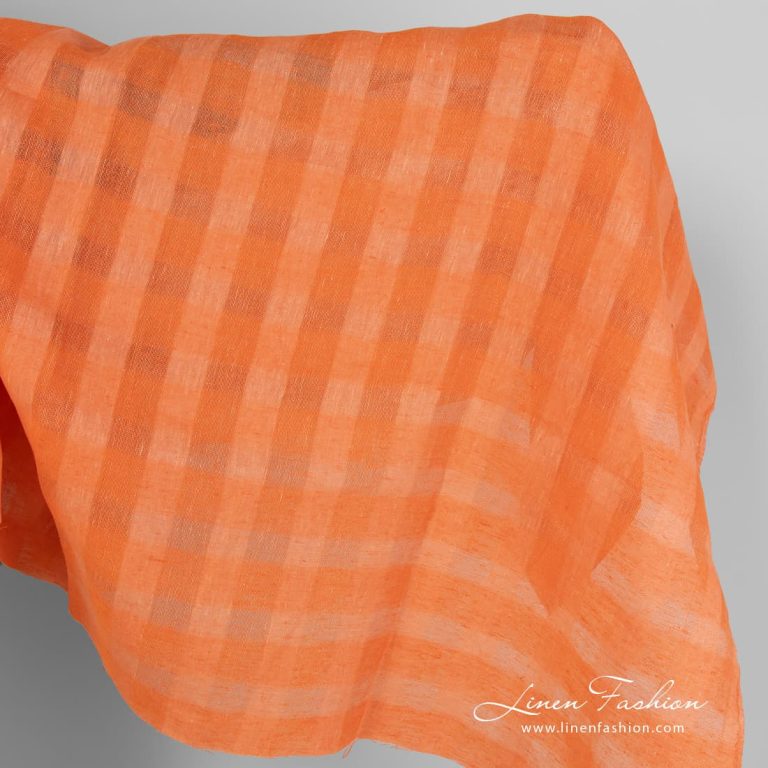 Linen fabric in peachy orange sheer checks.