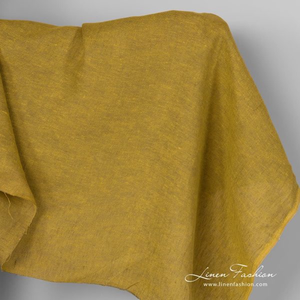 Yellow green linen fabric in diagonal pattern.