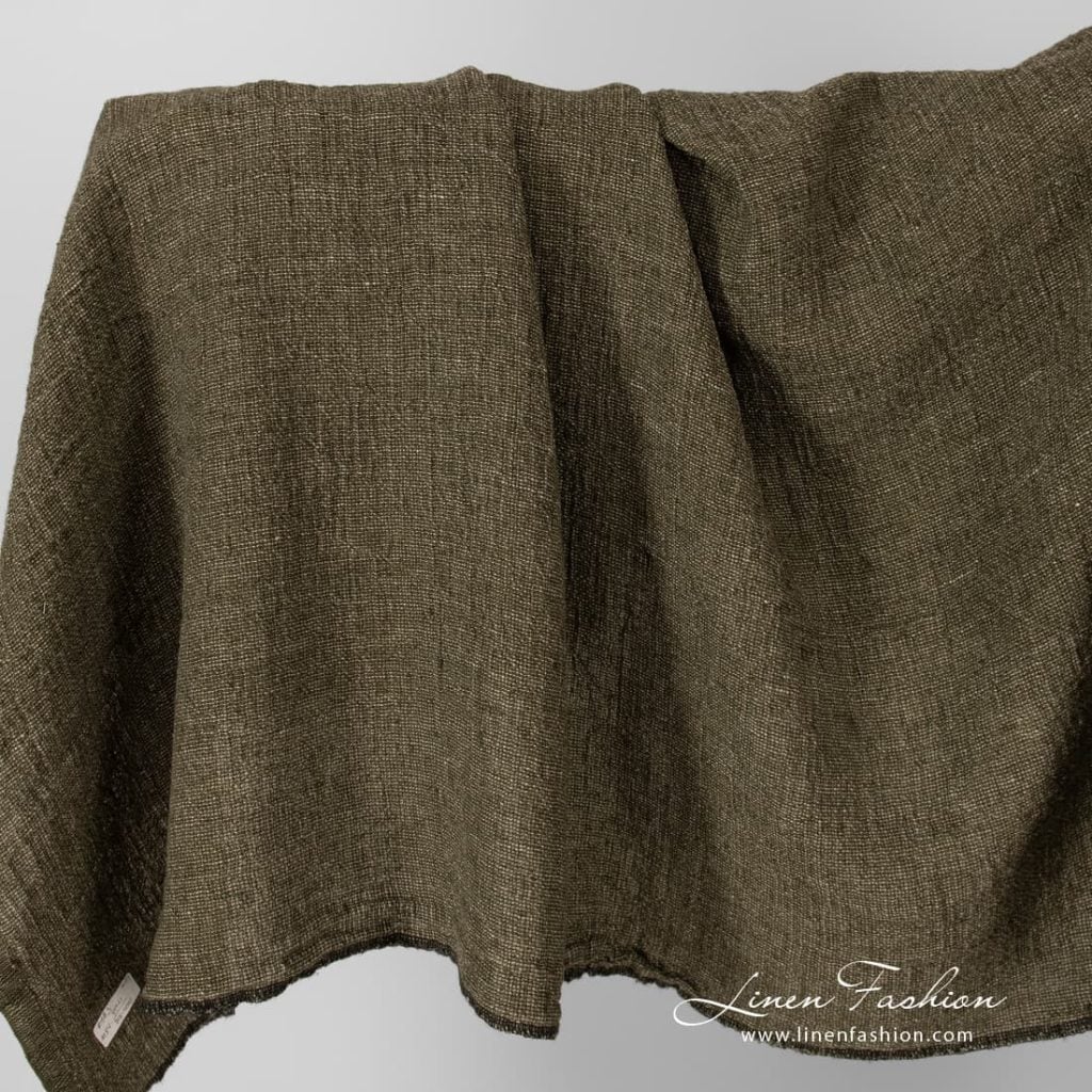 Linen fabric in moss green, washed.