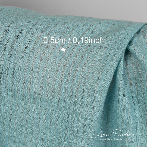 Linen fabric in transparent checks, woven from blue green yarns